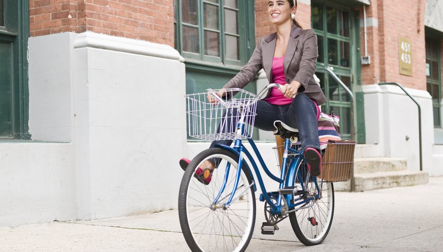 A woman is pedalling her bicycle. A woman is pedalling her bicycle.