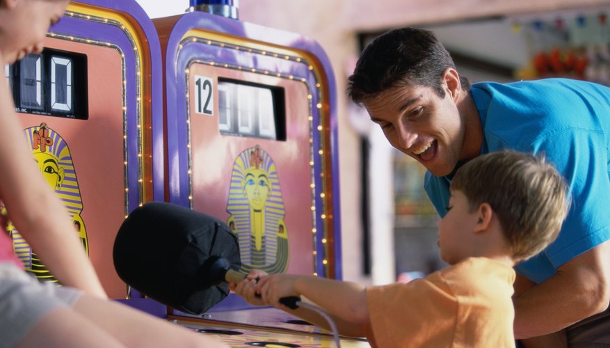 A young boy playing in an arcade. A young boy playing in an arcade.