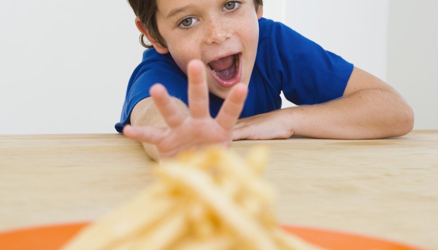 Junk foods containing high levels of salt, like french fries, can lead to high blood pressure. Junk foods containing high levels of salt, like french fries, can lead to high blood pressure.