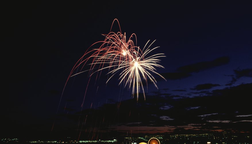 Fireworks exploding over a city skyline at night Fireworks exploding over a city skyline at night