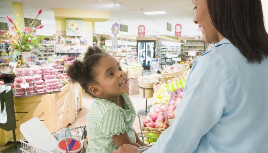 A mother talking to her young daughter at the grocery store. A mother talking to her young daughter at the grocery store.