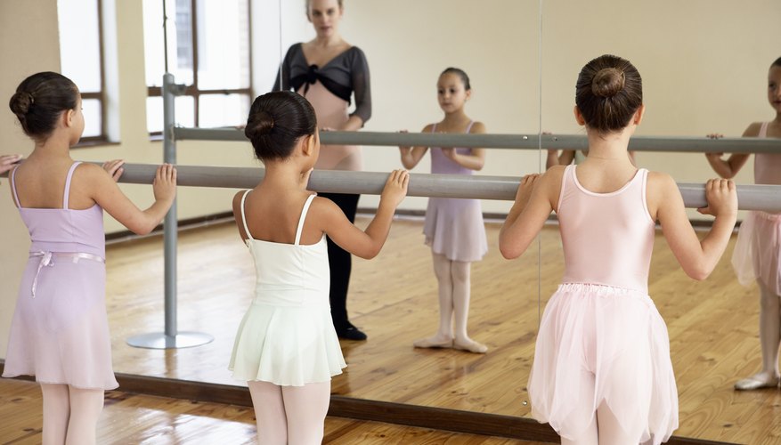 Young ballerinas holding a barre Young ballerinas holding a barre