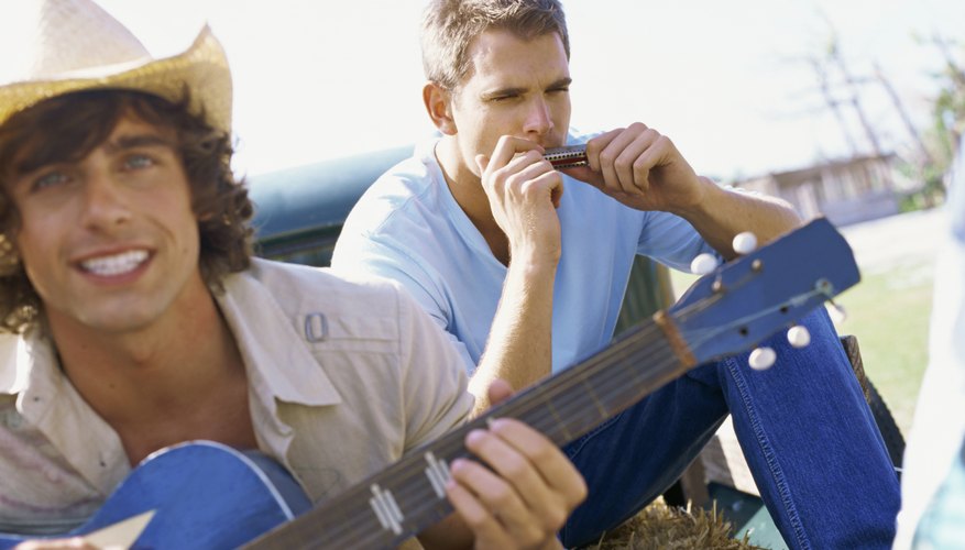 Photo Credit: Stockbyte/Stockbyte/Getty Images Guitar and harmonica player