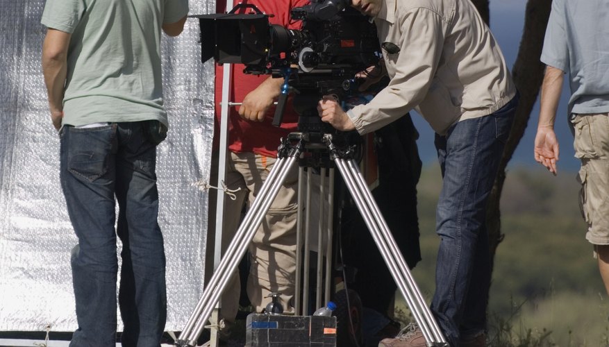 Photo Credit: lilly3/iStock/Getty Images Television filming crew