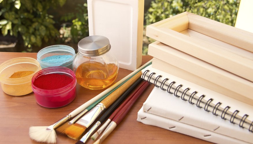A variety of painting supplies on an outdoor table. A variety of painting supplies on an outdoor table.