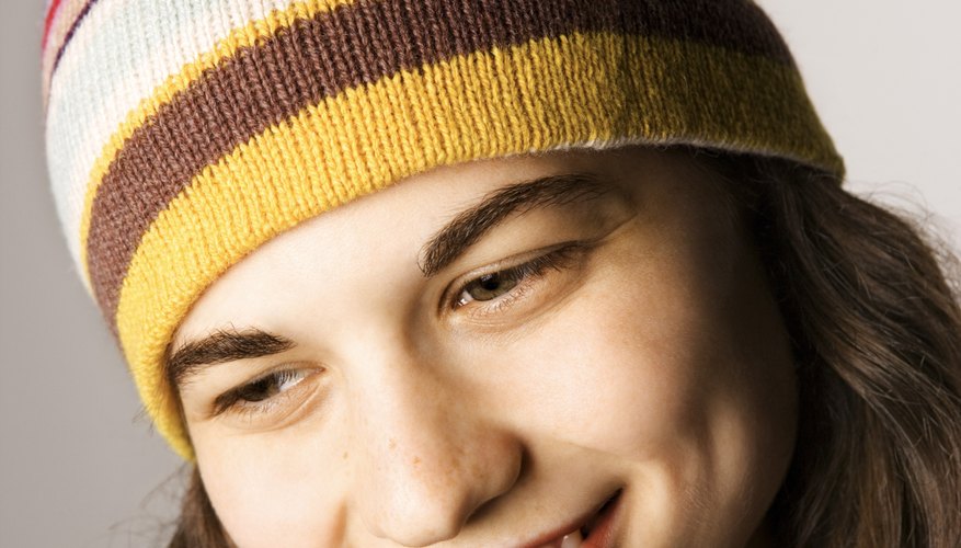 A fleece lining inside a knit hat is invisible from the outside. A fleece lining inside a knit hat is invisible from the outside.