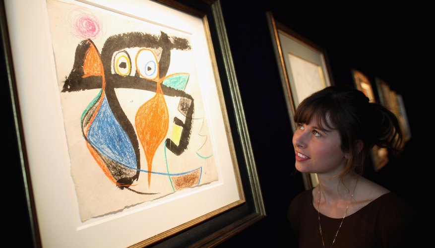 Photo Credit: Dan Kitwood/Getty Images News/Getty Images Woman viewing painting by Joan Miro named