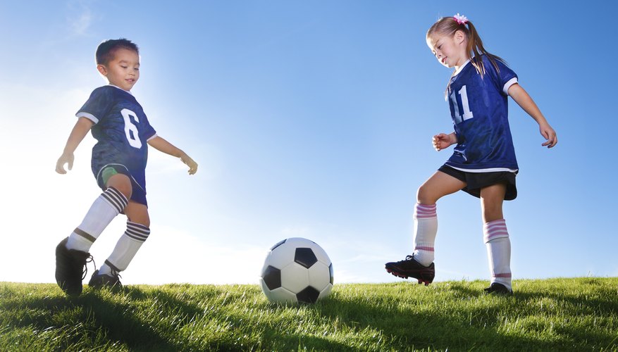 Boy and girl playing soccer Boy and girl playing soccer