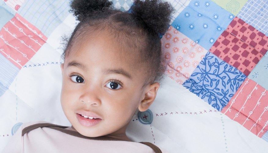 A simple block pattern makes an easy beginner crib quilt project. A simple block pattern makes an easy beginner crib quilt project.