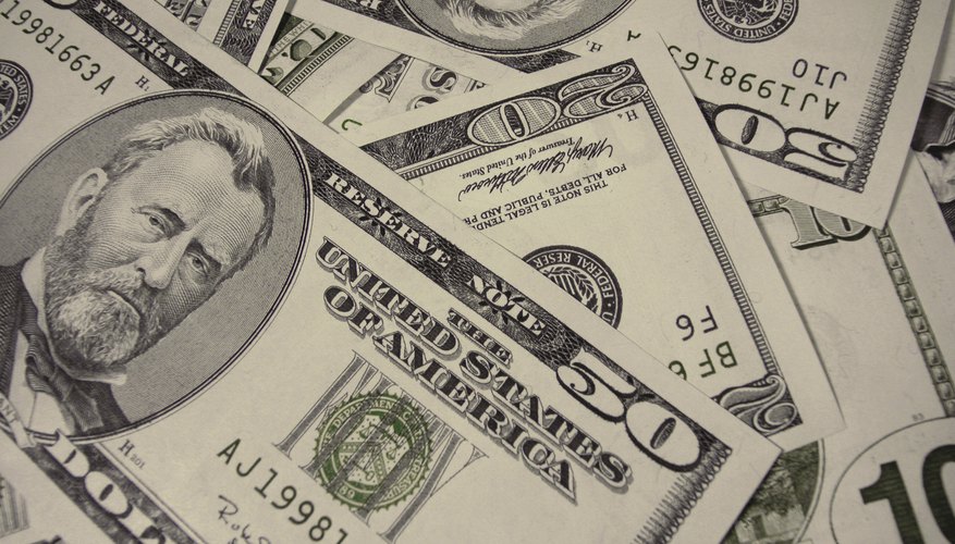 Photo Credit: Ablestock.com/AbleStock.com/Getty Images Pile of American money.