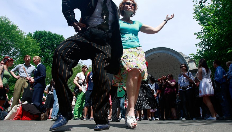 Couple swing dance in Central Park, NY Couple swing dance in Central Park, NY