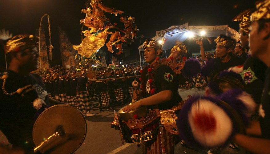 Members of gamelan playing music during nighttime festival Members of gamelan playing music during nighttime festival
