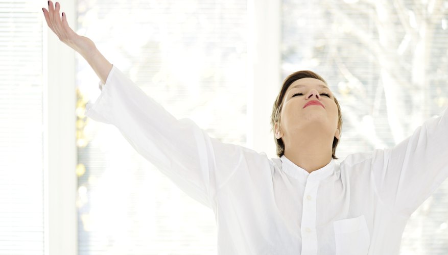 A woman is breathing in deeply inside. A woman is breathing in deeply inside.