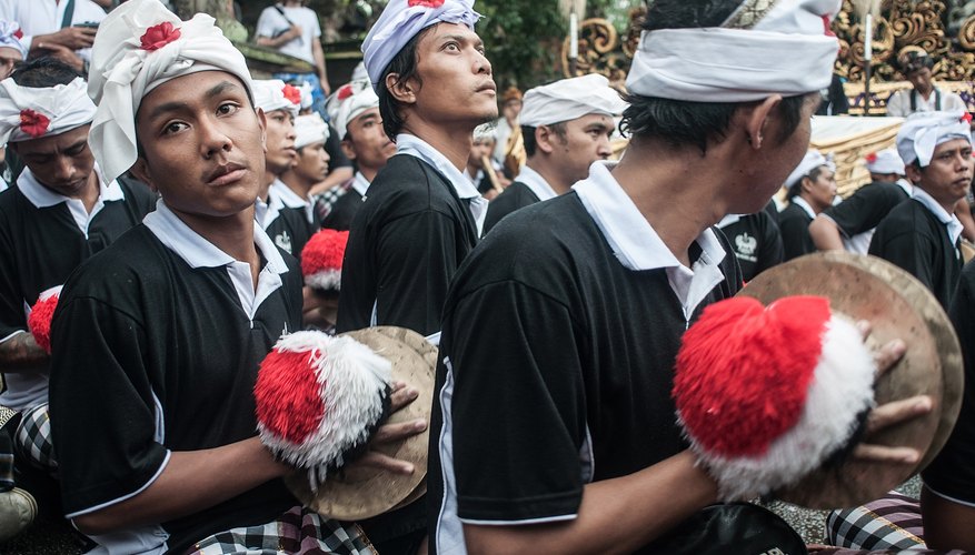 Men playing cymbals during parade in Bali Men playing cymbals during parade in Bali