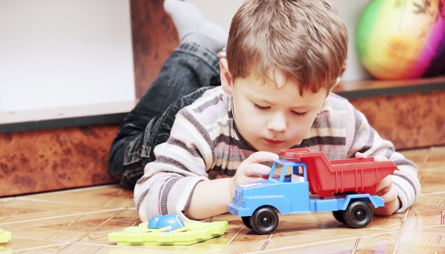 Young child playing with toy truck Young child playing with toy truck