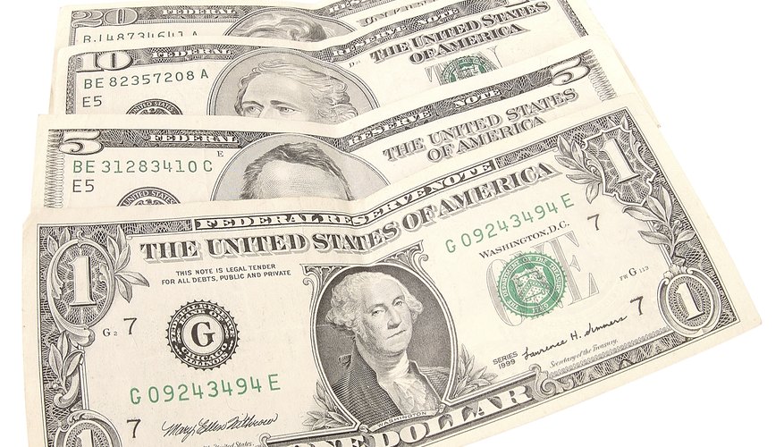 Fold a rectangular dollar bill into a square shape. Fold a rectangular dollar bill into a square shape.