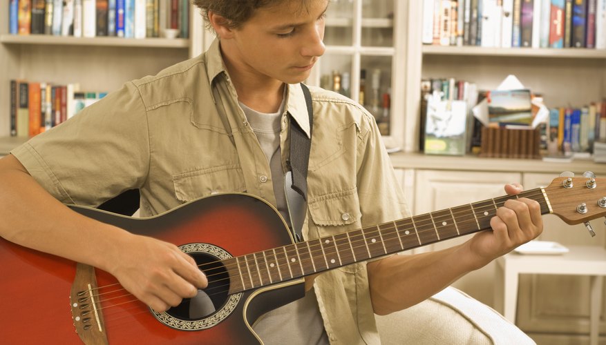 You play a classical guitar by plucking the strings with your fingers whereas you often play an acoustic guitar using picks You play a classical guitar by plucking the strings with your fingers whereas you often play an acoustic guitar using picks