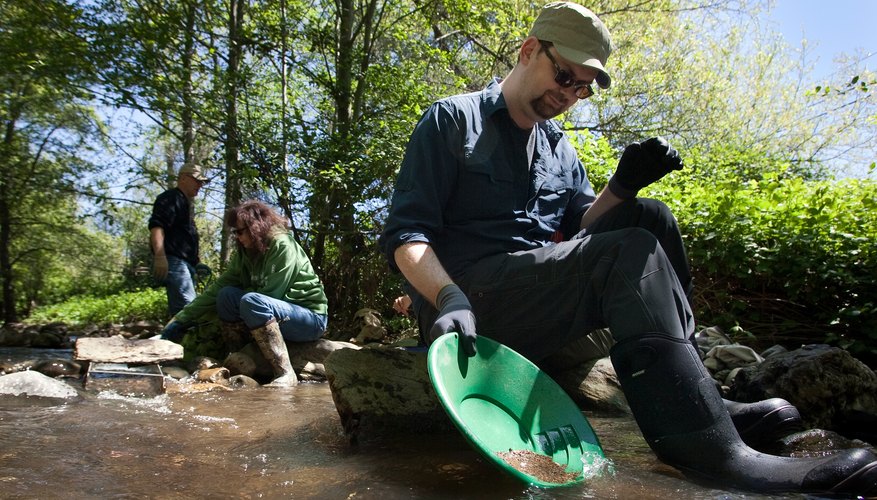 People pan for gold in streams in California's gold country. People pan for gold in streams in California's gold country.
