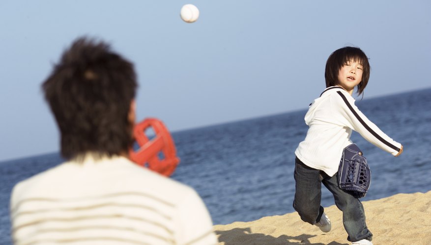 Young boy throwing baseball to father Young boy throwing baseball to father