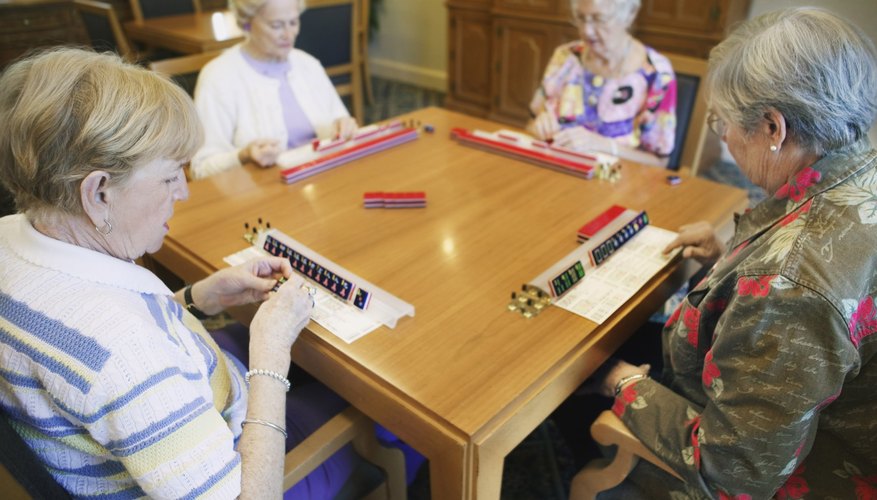 group of four people playing Mahjong group of four people playing Mahjong