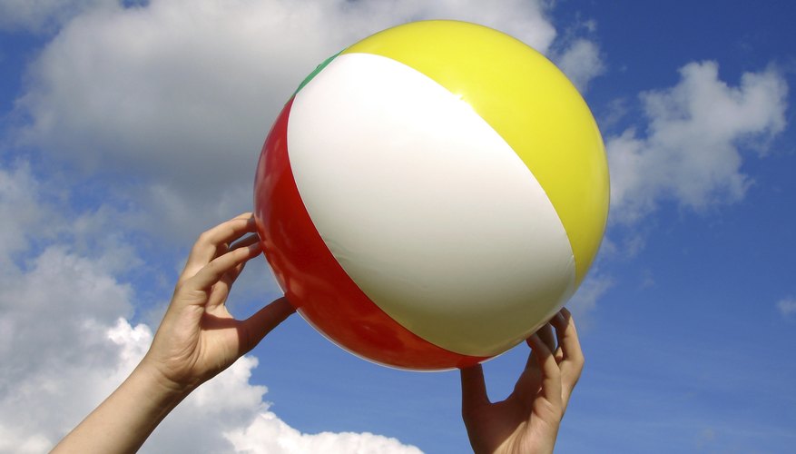Close-up hands holding up a beach ball Close-up hands holding up a beach ball