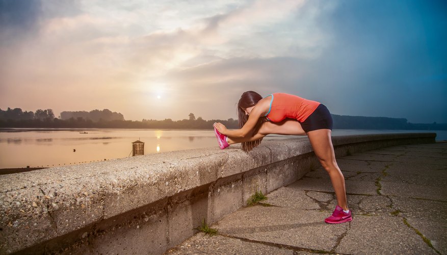 A woman wearing Spandex stretches before a run along an esplanade. A woman wearing Spandex stretches before a run along an esplanade.