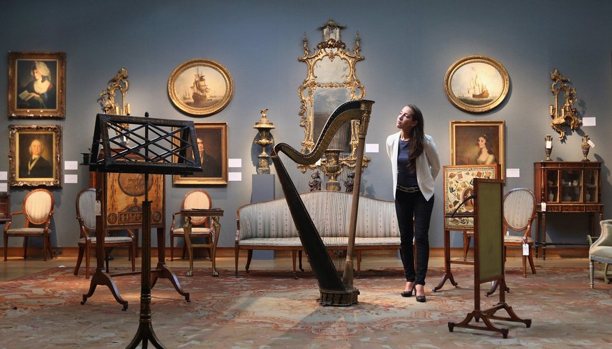 A Christie's Auction House assistant admires a Regency double-action harp before its auction in London in 2013. A Christie's Auction House assistant admires a Regency double-action harp before its auction in London in 2013.