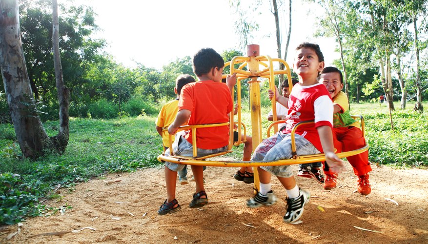 Kids play on a merry-go-round. Kids play on a merry-go-round.