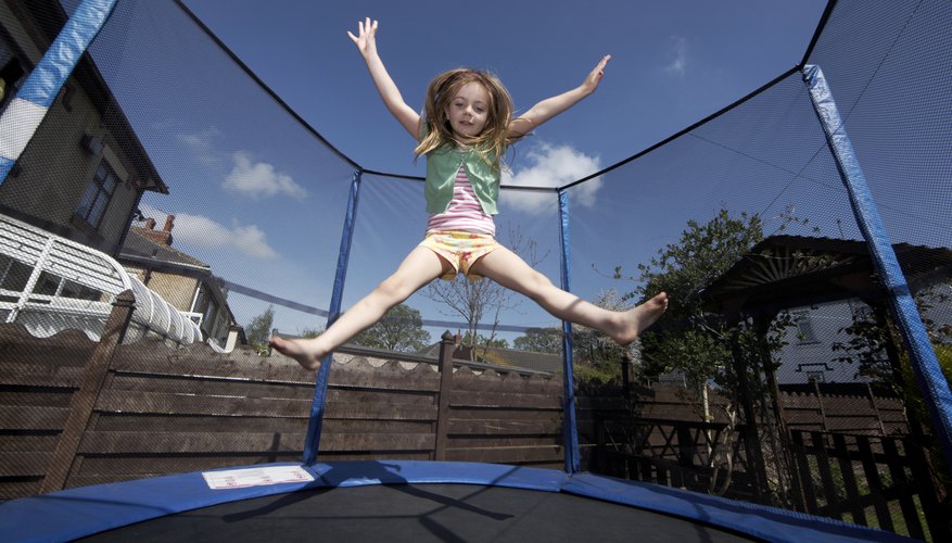 A young girl jumping on a trampoline. A young girl jumping on a trampoline.
