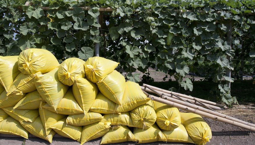Bags of organic fertilizer on the ground by plants. Bags of organic fertilizer on the ground by plants.