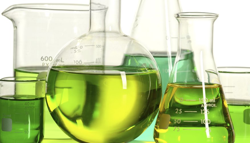 Clear containers with green liquid. Clear containers with green liquid.