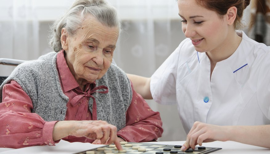 Senior playing checkers with a nurse Senior playing checkers with a nurse