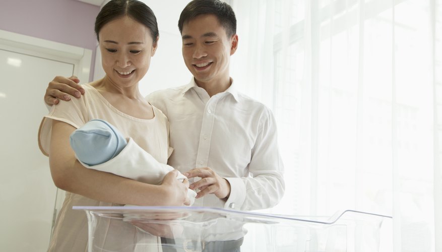 Parents holding their newborn in hospital. Parents holding their newborn in hospital.