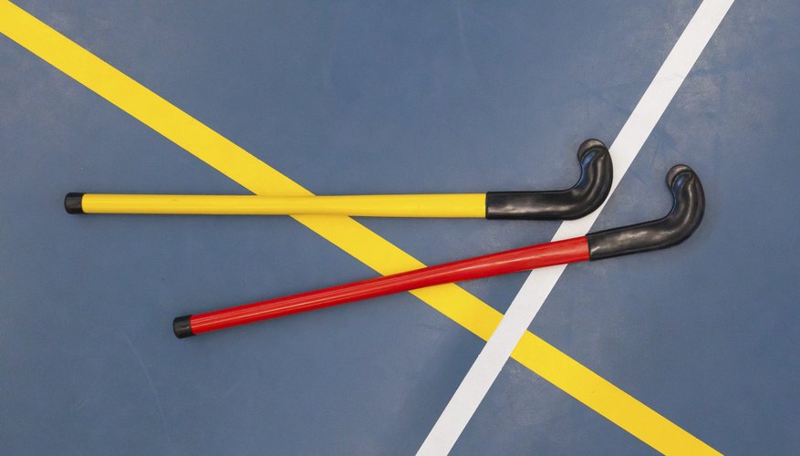 Floor hockey sticks laying on a gym floor. Floor hockey sticks laying on a gym floor.
