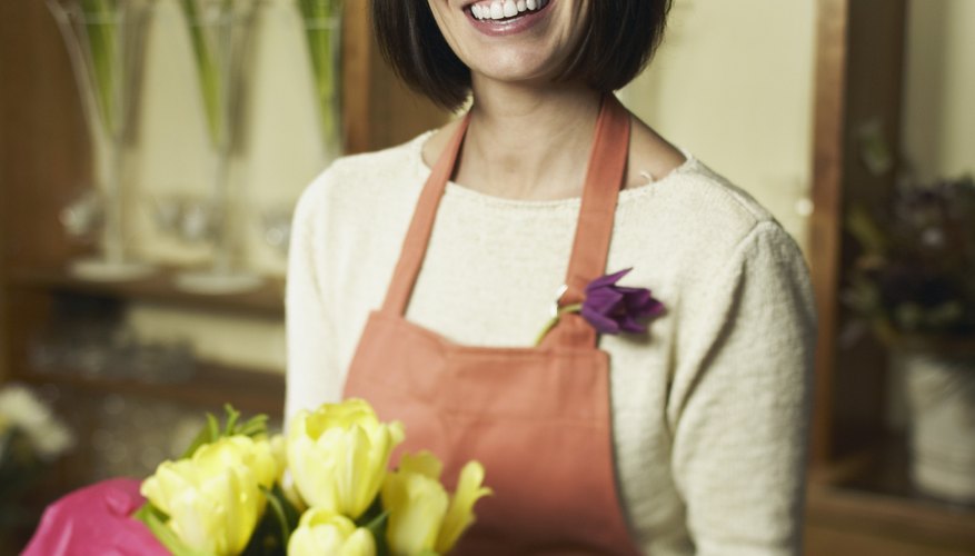 Woman arranging flowers Woman arranging flowers