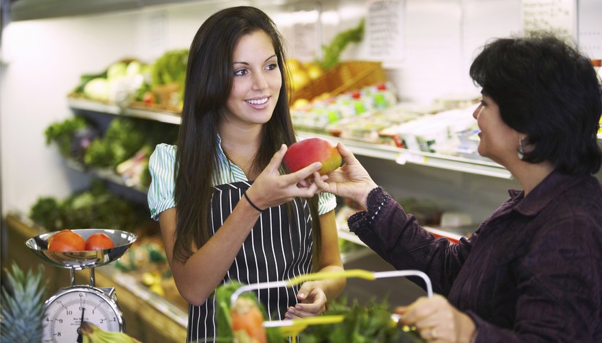 Teenager working at grocery store. Teenager working at grocery store.