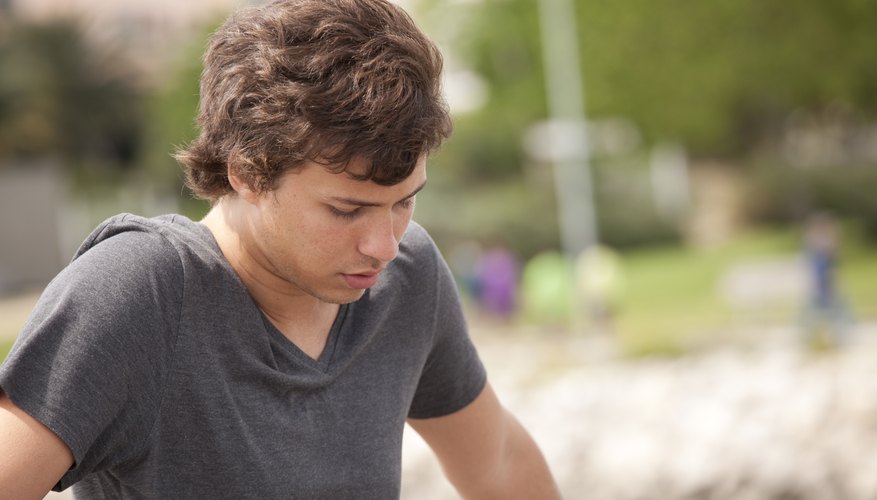 Teenage boy looking down Teenage boy looking down