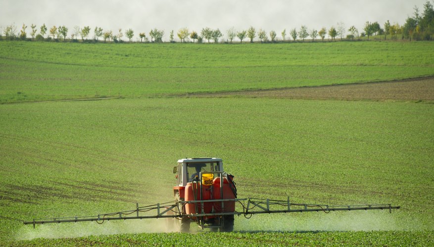 A farmer is spreading fertilizer. A farmer is spreading fertilizer.