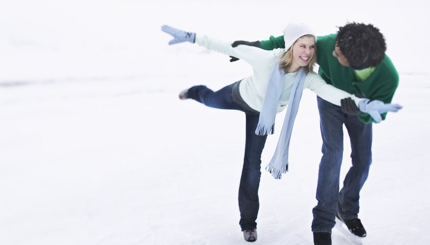 A woman and man are ice skating together. A woman and man are ice skating together.