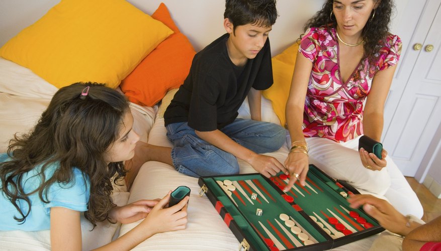 Family playing board game. Family playing board game.