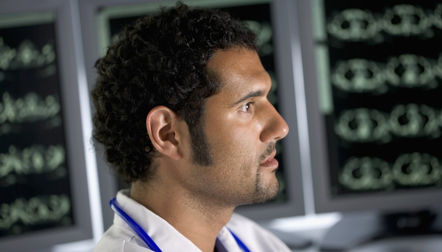 Doctor looking over brain scan results Doctor looking over brain scan results