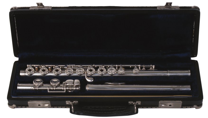 Flute cleaning rods come somewhere inside the flute case, here fitted beneath the foot and headjoint. Flute cleaning rods come somewhere inside the flute case, here fitted beneath the foot and headjoint.