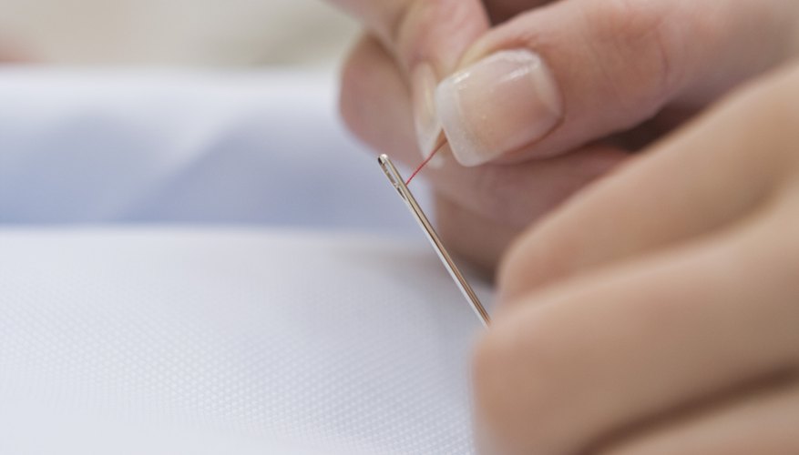 Photo Credit: Jupiterimages/BananaStock/Getty Images Fine linens or heirloom garments such as christening gowns may have hand-embroidered scalloped edges.