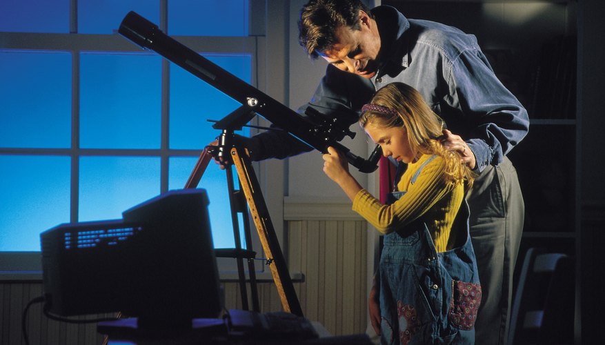 child looking through telescope child looking through telescope