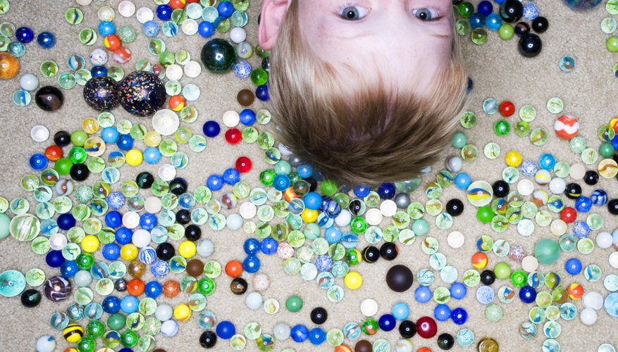 Photo Credit: Fuse/Fuse/Getty Images Young boy surrounded by marbles