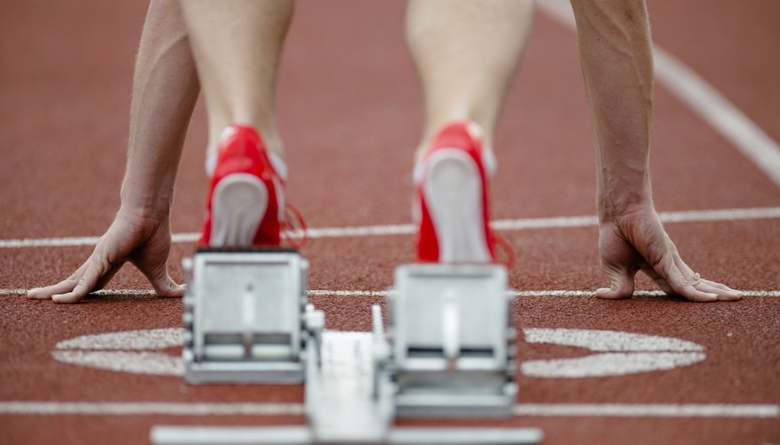 Close-up of a runner's feet on a track. Close-up of a runner's feet on a track.