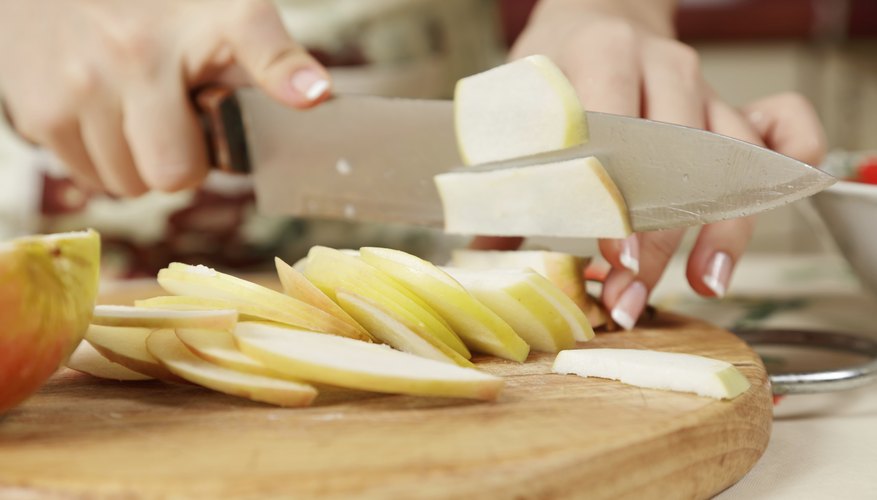 A woman is slicing an apple. A woman is slicing an apple.
