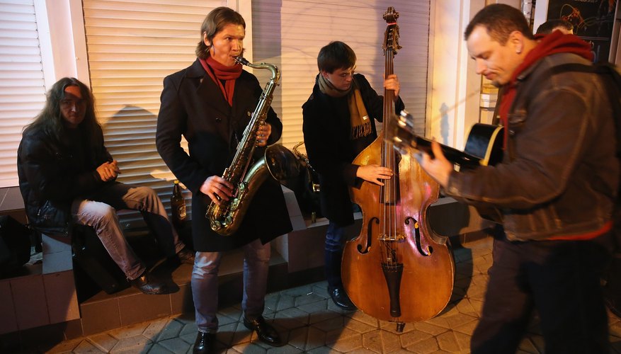A group of jazz musicians playing in street. A group of jazz musicians playing in street.
