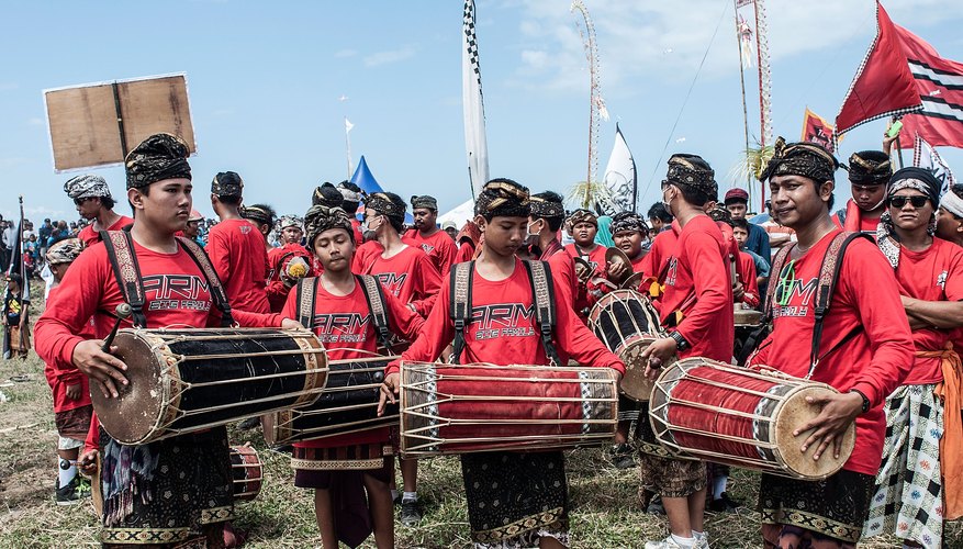 Men playing traditional Bali music with kendang Men playing traditional Bali music with kendang