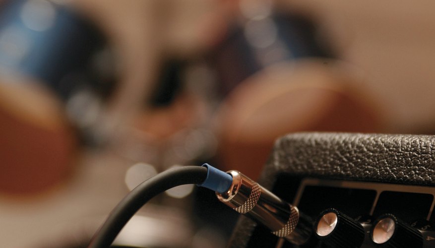 A cable is plugged into an amplifier. A cable is plugged into an amplifier.
